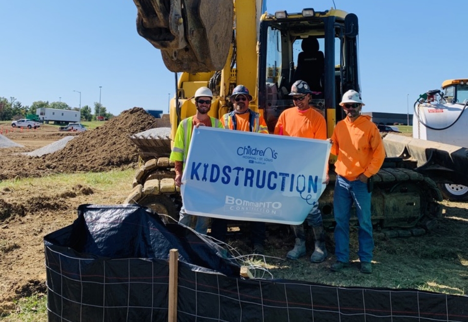 Construction Crew Holding KIDstruction Sign